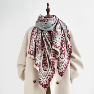 Detail of vintage paisley pattern and short fringe on thick cashmere-like shawl scarf