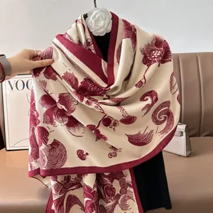 Detail of vintage floral knit shawl with burgundy flower patterns and soft cashmere texture