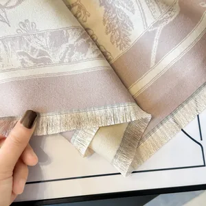 Close-up of floral cashmere feel shawl with purple patterns and delicate fringe details
