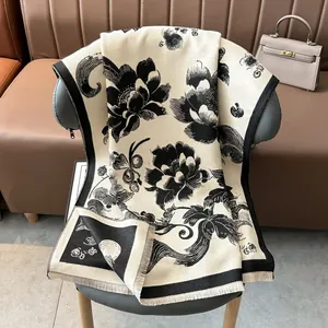Close-up of thick floral jacquard scarf with detailed fringe edges on leather chair