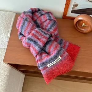 Détail d'une écharpe en laine montrant la maille épaisse et les franges
