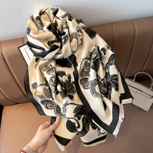 Close-up of vintage black floral print and fine fringe details on a thick shawl