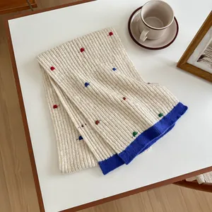 Knitted wool scarf in cream with colorful dots and bold blue color block border