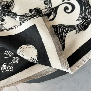 Detail of vintage cashmere-feel shawl with black and white animal motifs and fringe trim