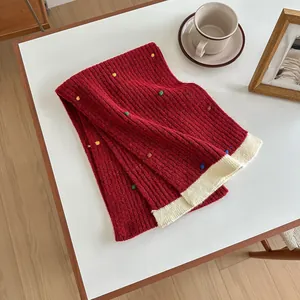 Detailed texture of thick knit wool scarf with colorful polka dots and ribbed pattern