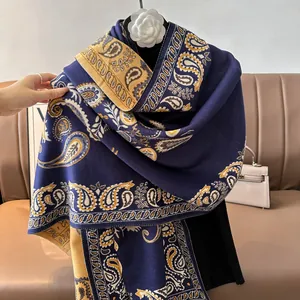 Detail of paisley pattern on a thick reversible cashmere shawl with elegant draping