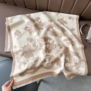 Detail of vintage floral cashmere-like shawl with thick fringe on a leather chair