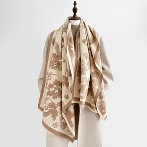 Detail of elegant floral cashmere scarf with delicate fringe edges and soft texture