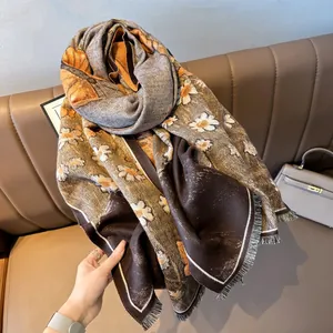 Close-up of retro daisy print pashmina scarf with delicate fringe edges and soft texture