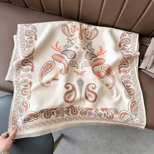 Detail of paisley pattern on thick pashmina shawl with tassel fringe on a leather sofa