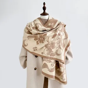 Detail of vintage beige pashmina shawl featuring brown floral jacquard and tassel edges