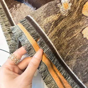Detailed macro view of soft cashmere scarf fabric with elegant fringe and cat pattern