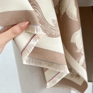Detail of vintage cashmere-like scarf showing premium fringe trim and jacquard texture