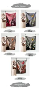 Detail view of woven cat and butterfly shawls in red, blue, ginger, green, and grey