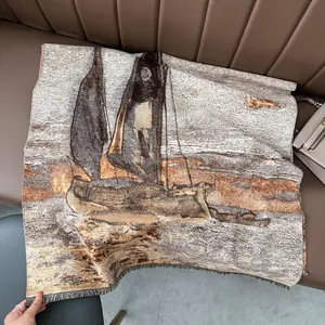 Detalle de bufanda tejida gruesa con motivo de pintura al óleo velero y flecos en tonos tierra