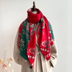Close-up of red and green paisley jacquard scarf with thick fabric and tassel edge details