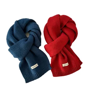 Navy blue and red knitted wool scarves in a stylish knot fold on white background