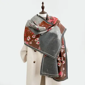 Detail of faux cashmere scarf with artistic deer patterns and fine fringe trim edges