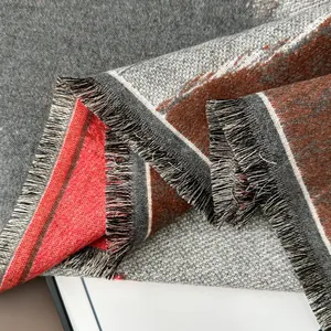 Detailed close-up of woven cashmere-like scarf texture with multicolor striped fringe