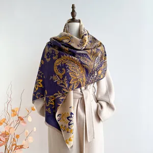 Detail of paisley jacquard scarf showing double-sided woven pattern and fringe tassels