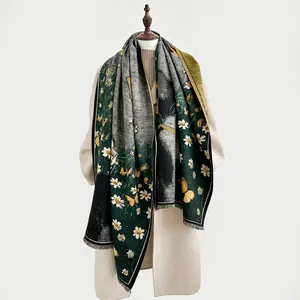 Detail of dark green cashmere shawl with butterfly patterns and delicate tassels
