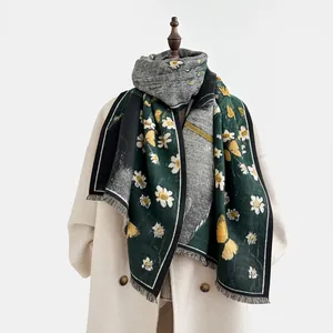 Detail of dark green cashmere-feel shawl featuring white daisies and butterfly prints