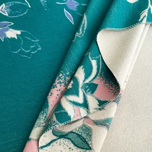 Macro view of floral jacquard shawl showing twill weave texture and reversible double-sided fabric
