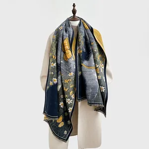 Detail of cashmere-like shawl featuring daisy and butterfly patterns with short tassels