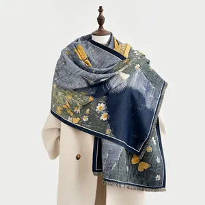 Close-up of winter shawl showing detailed navy floral patterns and soft tassel fringe