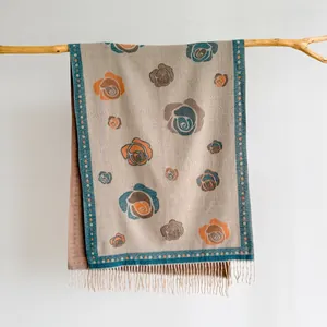 Close-up of vintage camellia floral pattern and fringe tassels on cashmere-like scarf