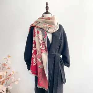 Detail of elegant floral jacquard scarf with fringe trim on a grey wool coat
