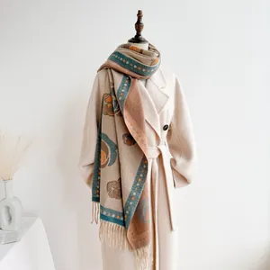 Close-up of vintage floral jacquard scarf with elegant tassels on a wool coat