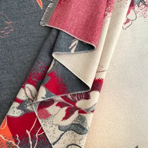 Close-up of jacquard floral pattern and fine fringe edge on thick cashmere-like shawl