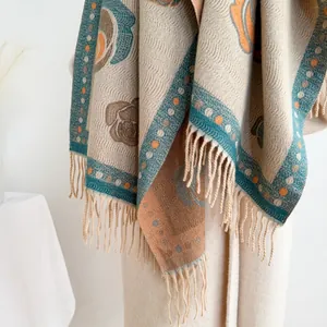 Detail of vintage camellia pattern cashmere-like shawl with intricate fringe tassels