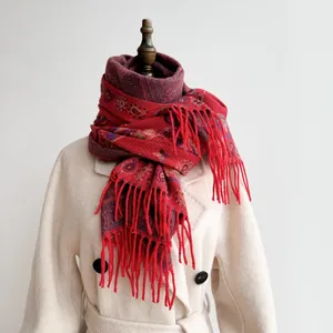 Bohemian paisley jacquard shawl with long tassels displayed on a white wool coat