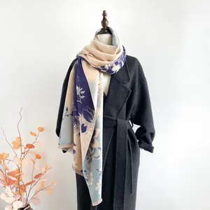 Detail of purple jacquard magnolia scarf with tassels on cashmere-feel fabric