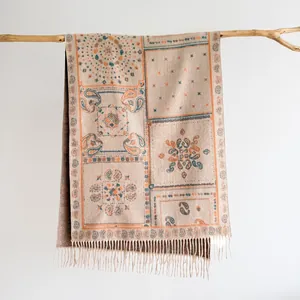 Close-up of Bohemian paisley jacquard shawl fabric texture with soft fringe tassels