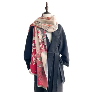 Elegant jacquard floral shawl with tassels on dark coat, thick warm winter wrap