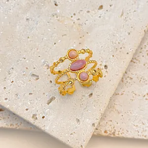 Detailed macro view of 18K gold plated triple band ring with pink natural gemstones