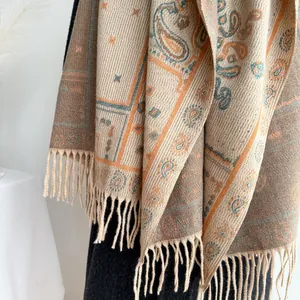 Detail of bohemian paisley jacquard shawl with decorative tassels and ethnic patterns