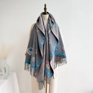 Macro shot of ethnic floral cashmere scarf with fringed edges and pink camellia pattern