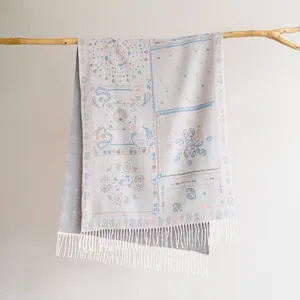 Detail of bohemian pashmina scarf with paisley patterns and soft white fringe tassels