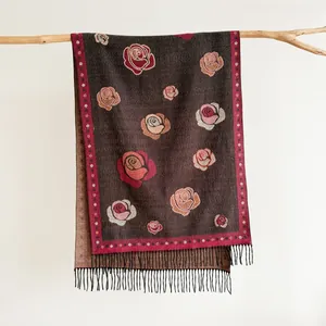 Detailed view of rose floral embroidery and black tassel fringe on vintage cashmere scarf