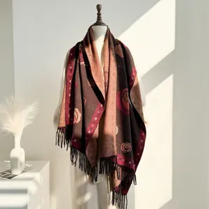 Detail of vintage floral cashmere scarf with rose patterns and long decorative tassels