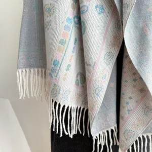 Macro detail of Bohemian paisley jacquard weave fabric and white fringe tassels