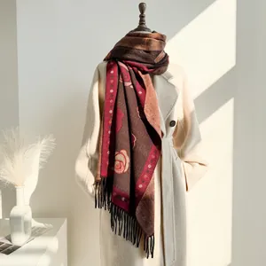 Close-up of vintage floral jacquard scarf with red camellia patterns and black tassels