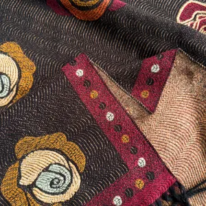 Macro shot of ethnic vintage camellia pattern and intricate woven texture of the shawl