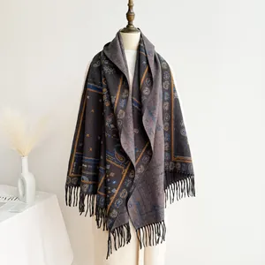 Close-up of retro paisley pattern and long black tassels on a bohemian shawl scarf