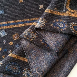 Detail view of ethnic paisley jacquard pattern on charcoal gray wool blend shawl fabric