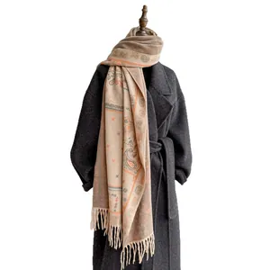 Bohemian paisley jacquard pashmina shawl with long fringes on grey woolen coat